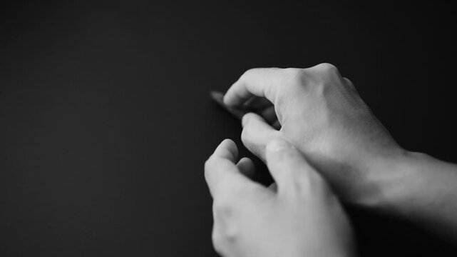 Authentic Paleolithic Biface Spear Head from Algerian Desert Held in Hand. slow motion video. black background. 4k at 50 fps