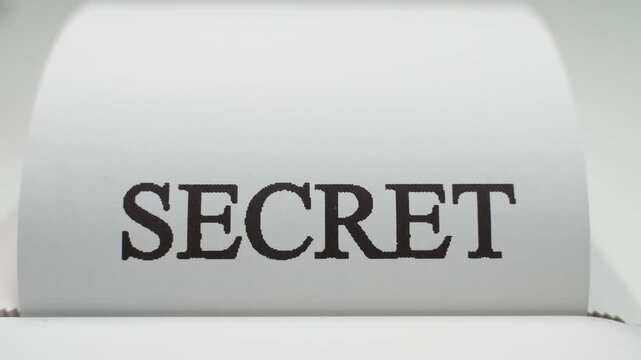 The word SECRET appears close-up on white paper