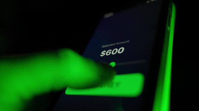 Debtor takes out a loan of 650 dollars via mobile app, close-up. Man stuck in loans
