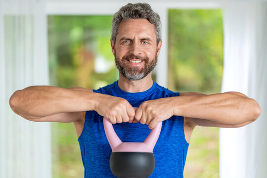 Strength and fitness training. Gym workout exercise, motivation. Sport determination. Sportsman do workout with kettlebell. Trainer do kettlebell lifting for strength at gym. Hardstyle swings