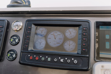 Fototapeta premium Dashboard display of a vehicle showing multiple gauges and indicators, including speedometer, tachometer, and warning lights in a modern design layout