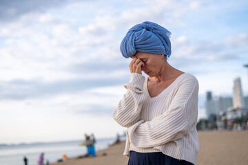 Woman wearing a headscarf common symbol of strength among cancer patients undergoing treatment chemotherapy symbolizes the continuation of life and hope amidst adversity emotional strength.