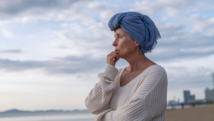 Woman wearing a headscarf common symbol of strength among cancer patients undergoing treatment chemotherapy symbolizes the continuation of life and hope amidst adversity emotional strength.
