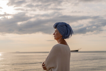 Woman wearing a headscarf common symbol of strength among cancer patients undergoing treatment chemotherapy symbolizes the continuation of life and hope amidst adversity emotional strength.