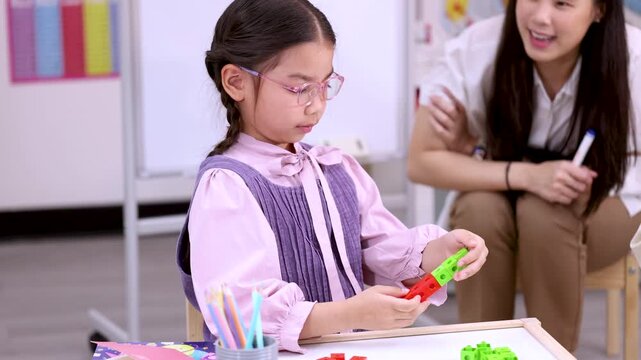 Elementary School Girl Counting Colorful Math Manipulative Blocks