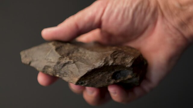 Perfectly Preserved Paleolithic Biface Pick: Authentic Stone Age Hand Tool and Prehistoric Artifact (slow motion 4K)