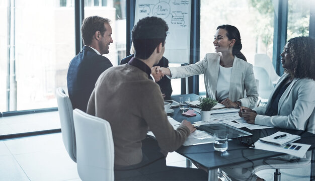 Woman, shaking hands and team at office meeting with success, promotion or b2b collaboration. Business people, handshake and smile with deal, agreement or achievement with project at finance agency