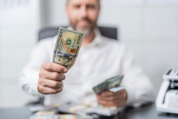 Rich businessman saving cash money. Financial saving success. Successful rich man with money. Business success man hold dollar. Millionaire hold dollar money. Riches and success. Selective focus