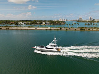 Yacht boat tour. Luxury boat yachting. Motorboat sailing at sea. Luxury charter yacht in sea. Motor yacht luxury vessel. Sea motor boat. Sea summer vacation. Aerial motorboat. Miami vibes