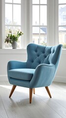A light blue tufted armchair sits near a sunlit window