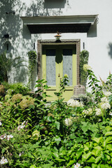 Green garden entrance with hydrangea flowers for landscaping and home exterior design concept