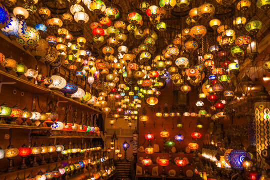 Colorful lanterns illuminate a shop interior in Istanbul Grand Bazaar, popular souvenirs and traditional lighting for tourists.
