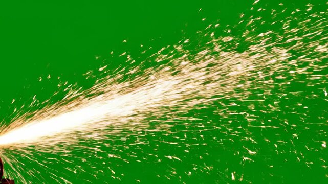 Isolated brilliant shower of industrial grinding sparks flying diagonally across a solid chroma key green screen background ready for compositing and visual effects use isolated, technology, green