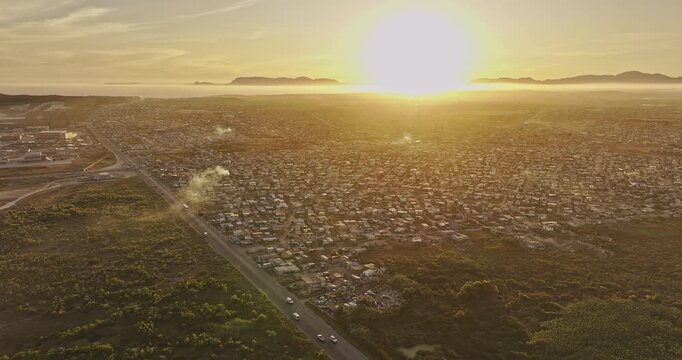 Cape Town South Africa Aerial v101 flyover Baden Powell Dr capturing densely populated Khayelitsha township in sunset's golden glow - Shot with Mavic 3 Pro Cine - Jan 11th 2024