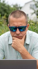 Freelancer working on laptop in garden featuring working, garden, work, relaxing, technology, freelancer, laptop