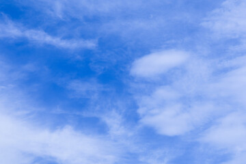 Fototapeta premium Bright Blue Sky with Scattered White Clouds