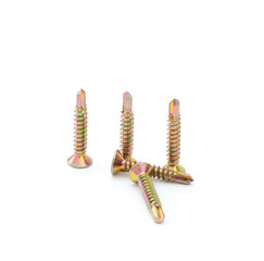 Pile of yellow zinc plated self-drilling screws isolated on white background.