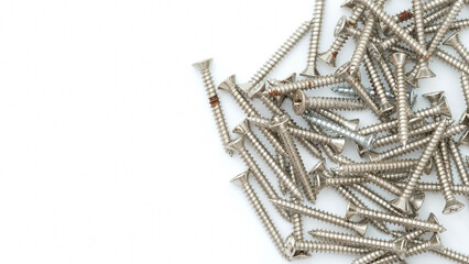 Top view of group of silver stainless steel wood screws isolated on white background.