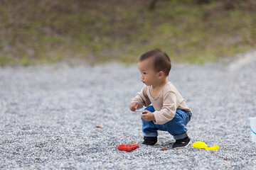 Baby play dig stone at outdoor park