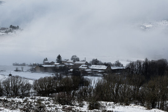 Snow-covered town and cloudy sky in the Pyrenees