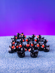 A close-up of a set of black, playful duck-shaped interior figurines arranged  on a wooden stage