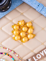 A close-up of a set of orange, playful turtle interior figurines arranged on a leather surface.