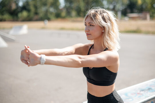 Blonde Woman Stretching Arms Outdoors