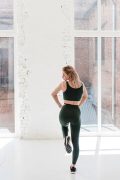 Confident active woman in sport clothing posing on camera