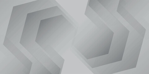 Abstract geometric pattern with repeating hexagonal shapes in shades of grey and white, creating a modern and minimalist background.