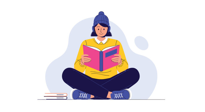 Young woman wearing a beanie and headphones sits cross-legged on the floor, deeply engrossed in reading an interesting book.