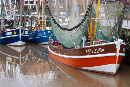 harbor area at friesland with fishermens ships and fishing nets hanging for drying after catch of the day
