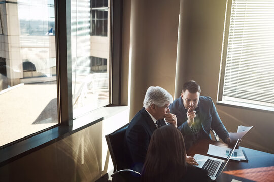 Business, meeting or people with thinking at laptop for case preparation, trial insight or solution. Flare, above or lawyer team with tech at law firm for risk mitigation or judicial hearing decision