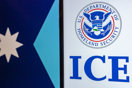 Quito, ECUADOR - Jan 25 2026 : U.S. Homeland Security ICE logo beside a section of the Minnesota state flag in the background.