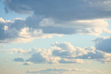 Fototapeta premium Sunbeams break dramatically through dense clouds in the blue sky.
