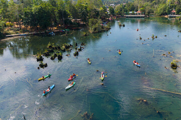 Aerial view of kayaking in crystal clear water at Klong Root, Krabi, Thailand, surrounded by lush tropical mangrove forest.