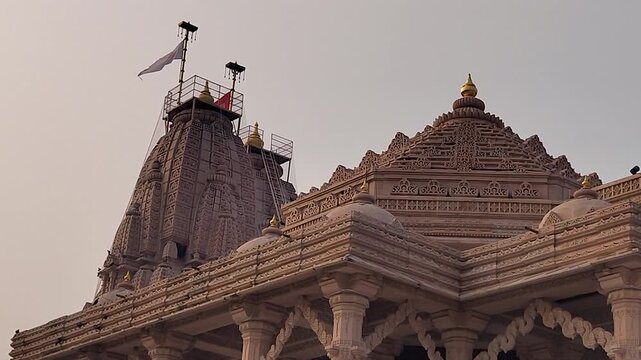Shri Valinath Mahadev Mandir in Tarabh Mehsana Gujarat India highlighting tall shikhara detailed stone carvings sacred flag and traditional Hindu temple architecture against sky.