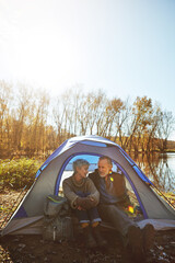 Camping, senior couple and talking in tent in nature for travel adventure, weekend getaway or support. Mockup space, old people and relax on campsite for bonding together, retirement break and chat