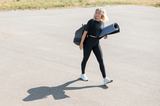 Woman with Yoga Mat and Gym Bag
