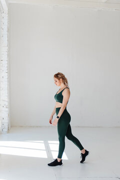 Attractive woman with muscular body posing on camera