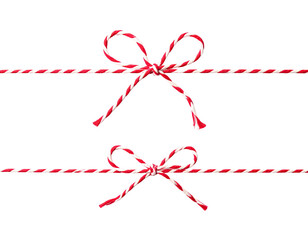 Two festive bows, crafted from red and white striped twine, floating on a black background