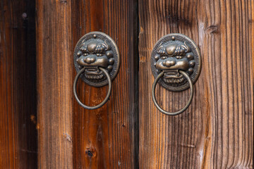 Traditional Door Knockers on a Wooden Door in Lukang Old Street.
