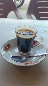 Aceh coffee is served in a clear glass with a distinctive spiced taste and aroma accompanied by delicious, rich Acehnese fried rice
