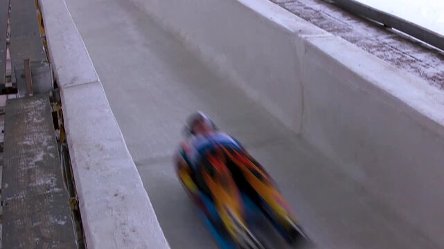 Luge athlete racing down the ice track