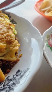 Aceh coffee is served in a clear glass with a distinctive spiced taste and aroma accompanied by delicious, rich Acehnese fried rice
