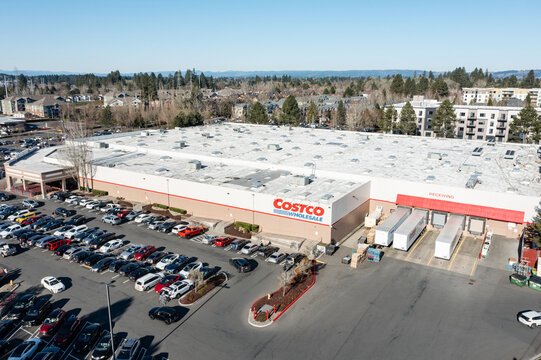Beaverton, Oregon, USA - Jan 24, 2026 - Aerial drone photo of Costco Wholesale store showing the large warehouse building, busy customer parking lot, delivery loading area, surrounding streets 