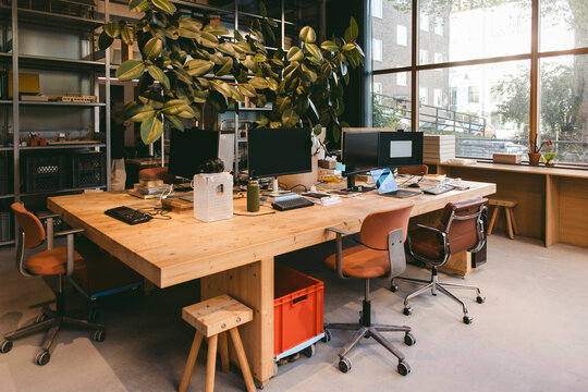 Interior of empty design office with computers on desk