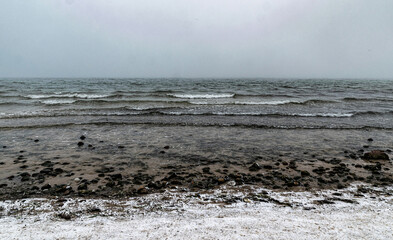 Winter frozen Baltic Sea shore. Lapping waves