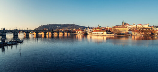 Fototapeta premium Cityscape panorama of Prague with Charles Bridge over Vltava River, beautiful buildings of Mala Strana and Hradcany Castle in morning light, Czech Republic
