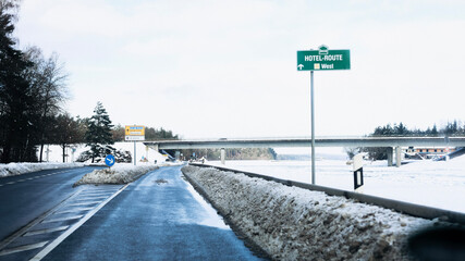 Fototapeta premium Trees have fallen in the forest due to snow, trees are lying on the roads, roads are closed, snow chaos in Germany, shoveling snow, snow in the forest, snow on the cars, snow in the village