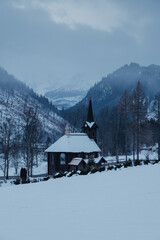 Picturesque view of the wooden church in Tatranska Javorina, Slovakia. A charming landmark surrounded by the majestic High Tatra Mountains.
